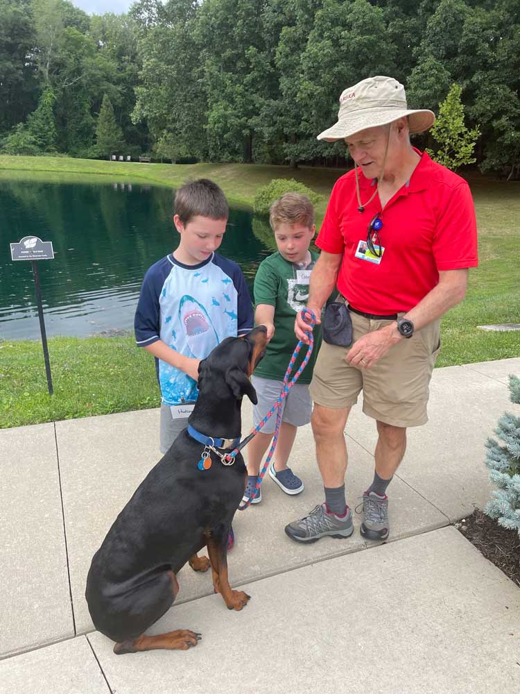 Camp Waves of Hope 2024 animal-assisted therapy dogs and boys