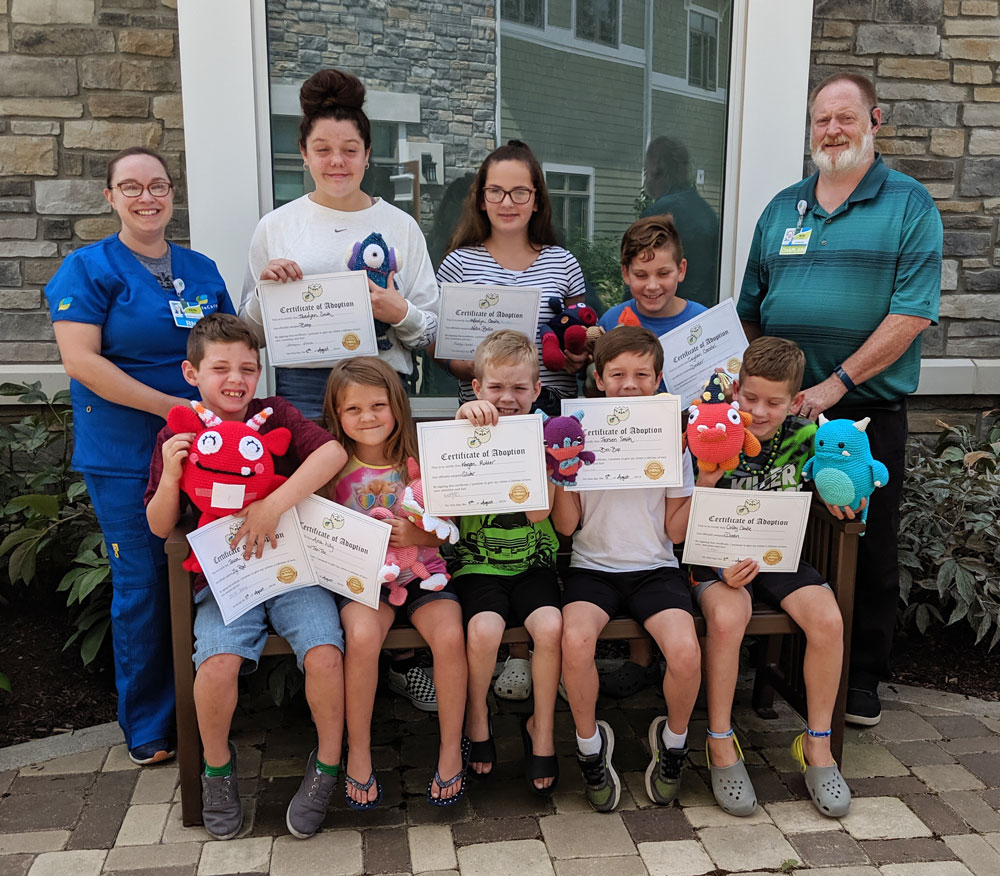 Caring Critters kids receiving their critter and adoption certificate