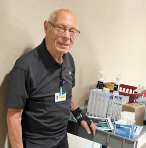 Volunteer Pushing Supply Cart