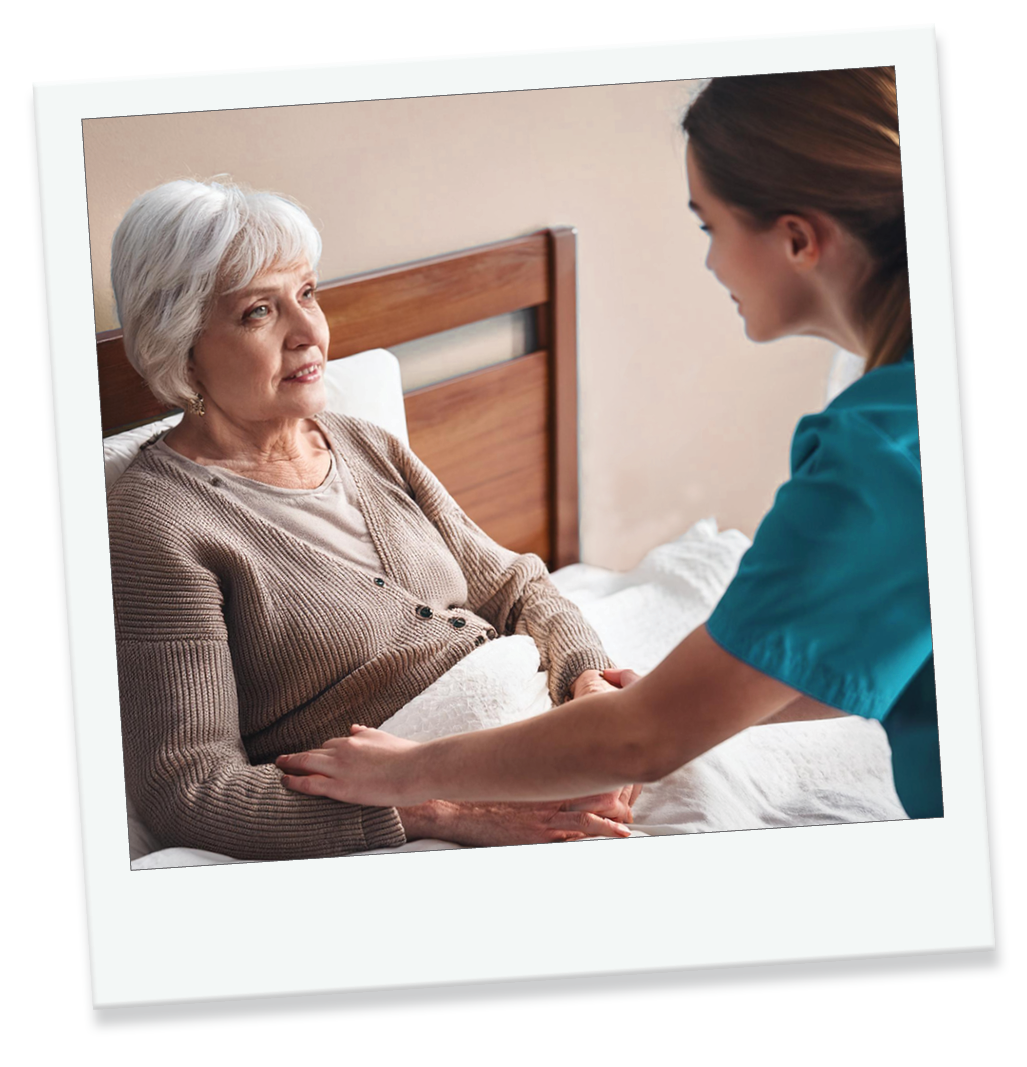 Female nurse assisting female patient at end of life